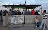 Palestinian construction workers wait to cross into Israel, at the checkpoint at the entrance to the West Bank Jewish settlement of Beitar Illit, November 28, 2010 (illustrative photo: Yaakov Naumi/Flash90)