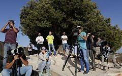 Journalists stand on a hill overlooking the Gaza Strip at the height of Operation Protective Edge, July 13, 2014 (photo credit: Miriam Alster/FLASH90)