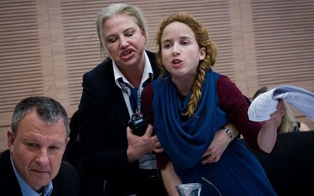 A security guard removes Labour MK Stav Shaffir from a Knesset Finance Committee meeting, December 8, 2014. (Photo credit: Miriam Alster / Flash90) A security guard removes Labour MK Stav Shaffir from a Knesset Finance Committee meeting, December 8, 2014. (Photo credit: Miriam Alster / Flash90)