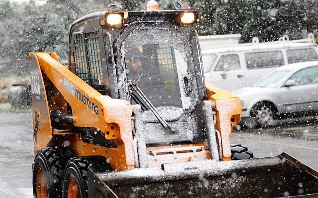 A tractor removes snow from the roads in Jerusalem, as stormy winter weather hit the capital region. January 9, 2015. (photo credit: Mendy Hechtman/FLASH90) A tractor removes snow from the roads in Jerusalem, as stormy winter weather hit the capital region. January 9, 2015. (photo credit: Mendy Hechtman/FLASH90)