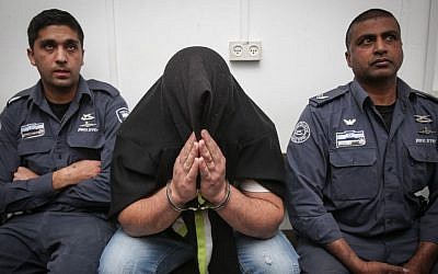 The male suspect of an arson attack in Pisgat Ze'ev is brought to the Jerusalem Magistrate's Court on February 2, 2015. (photo credit: Hadas Parush/Flash90)