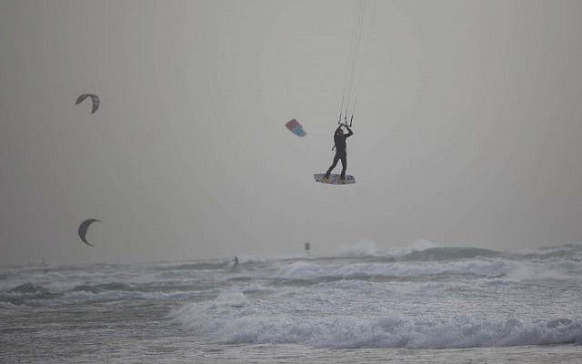 A windsurfer rides above churning waves off Tel Aviv on February 10, 2015, as a storm moves through the area. (photo credit: Yonatan Sindel/ Flash90) A kitesurfer rides above churning waves off Tel Aviv on February 10, 2015, as a storm moves through the area. (photo credit: Yonatan Sindel/ Flash90)