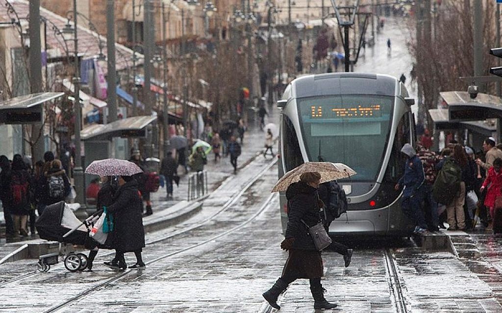 People walk in Jaffa Street in downtown Jerusalem on a stormy day, February 19, 2015. (photo credit: Yonatan Sindel/Flash90)