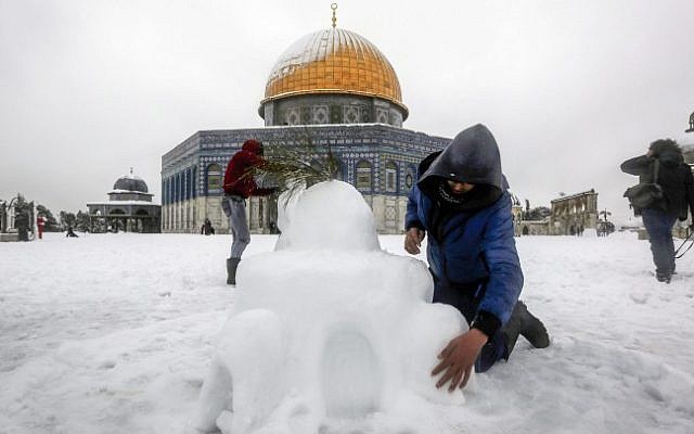 A Palestinian boy makes a statue with snow of the Dome of the Rock, at the al-Aqsa Mosque compound in Jerusalem's Old City, on a snowy winter morning. February 20, 2015 (Photo credit: Sliman Khader/Flash90) A Palestinian boy makes a statue with snow of the Dome of the Rock, at the al-Aqsa Mosque compound in Jerusalem's Old City, on a snowy winter morning. February 20, 2015 (Photo credit: Sliman Khader/Flash90)