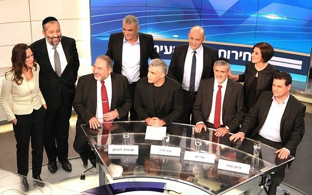 Foreign Minister and Yisrael Beytenu Chairman Avigdor Liberman (bottom L), Yair Lapid, leader of 'Yesh Atid' Party( bottom 2L), Leader of the Yachad party, Eli Yishai (bottom 2R), Leader of the combined Arab list, Ayman Odeh (bottom R), Meretz party leader Zahava Gal On (upper R), Leader of the ultra orthodox Shas party, Aryeh Deri (upper 2L), Leader of Habayit Hayehudi (Jewish Home) party, Naftali Bennett (upper 2R) and Leader of the Kulanu party Moshe Kahlon (upper C) and Channel 2 TV news anchorman, Yonit Levi (upper L) seen before a Channel 2 news political debate ahead of the 2015 Israeli election. in the Neve Ilan studios near Jerusalem on February 26, 2015. (Photo cedit: Channel 2 News)