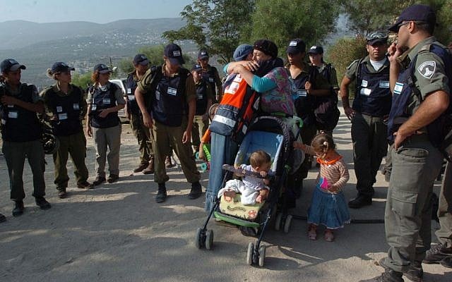 Two women hug before one leaves with her children from the settlement of Sa Nur in Gush Katif, as border police wait to evacuate her, August 23, 2005 photo credit: Nati Shohat/Flash90) Two women hug before one leaves with her children from the settlement of Sa Nur in Samaria, as border police wait to evacuate her, August 23, 2005 photo credit: Nati Shohat/Flash90)
