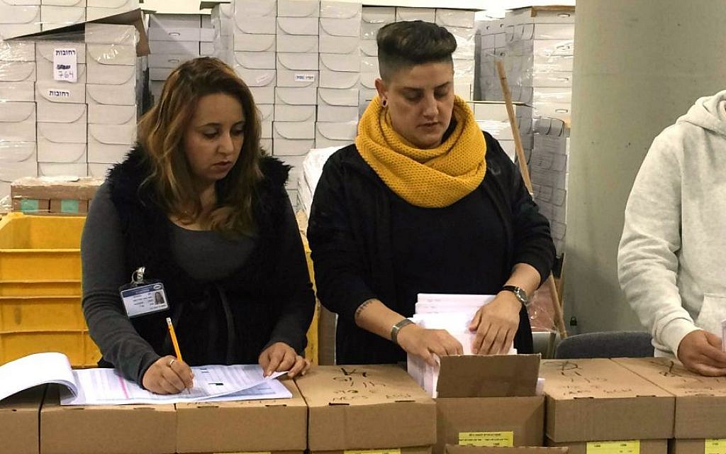 Central Elections Committee workers check voter registration lists, February 24, 2015. (Renee Ghert-Zand/Times of Israel) Central Elections Committee workers check voter registration lists, February 24, 2015. (Renee Ghert-Zand/Times of Israel)