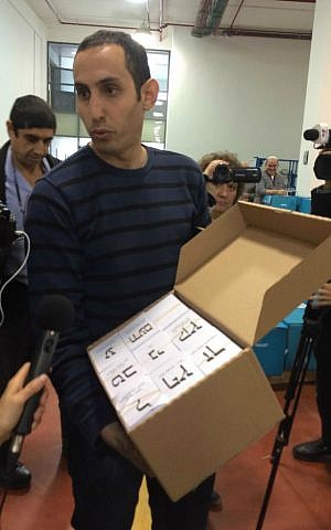 Central Elections Committee official Motti Geistman shows journalists visiting the CEC logistics center how ballots are packed to be sent to Israel's 10,150 polling places. February 24, 2015. (photo credit: Renee Ghert-Zand/TOI) Central Elections Committee official Motti Geistman shows journalists visiting the CEC logistics center how ballots are packed to be sent to Israel's 10,150 polling places. February 24, 2015. (photo credit: Renee Ghert-Zand/TOI)