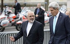 US Secretary of State John Kerry (right), speaks with Iranian Foreign Minister Mohammad Javad Zarif as they walk in Geneva, Switzerland, ahead of nuclear discussions, January 14, 2015. (AP/Keystone, Laurent Gillieron, File)