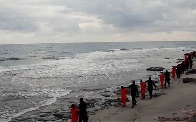 This image made from a video released February 15, 2015, by militants in Libya claiming loyalty to the Islamic State group purportedly shows Egyptian Coptic Christians in orange jumpsuits being led along a beach, each accompanied by a masked militant before the men are simultaneously beheaded. (AP Photo) This image made from a video released February 15, 2015, by militants in Libya claiming loyalty to the Islamic State group purportedly shows Egyptian Coptic Christians in orange jumpsuits being led along a beach, each accompanied by a masked militant before the men are simultaneously beheaded. (AP Photo)