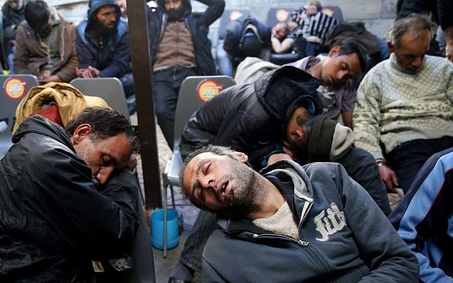 In this Tuesday, Feb. 3, 2015 photo, drug addicts sleep in their chairs at drop in center and shelter, south of Tehran, Iran. (AP/Ebrahim Noroozi) In this Tuesday, Feb. 3, 2015 photo, drug addicts sleep in their chairs at drop in center and shelter, south of Tehran, Iran. (AP/Ebrahim Noroozi)