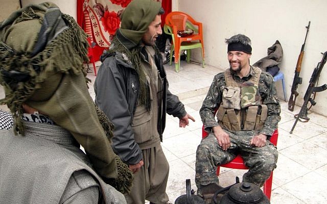 In this Thursday, Jan. 29, 2015 photo, Jordan Matson, 28, right, a former U.S. Army soldier, takes a break with other fighters from the main Kurdish militia, the People's Protection Units, or YPG, in Sinjar, Iraq. (Photo credit: AP/Vivian Salama) In this Thursday, Jan. 29, 2015 photo, Jordan Matson, 28, right, a former U.S. Army soldier, takes a break with other fighters from the main Kurdish militia, the People's Protection Units, or YPG, in Sinjar, Iraq. (Photo credit: AP/Vivian Salama)