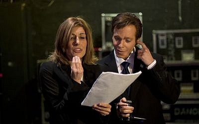 Comedians Roy Bar-Natan, right, and Shani Cohen read a script ahead of a recording of "Eretz Nehederet," a biting TV satire show, in Herzliya, Israel, January 26, 2015 (Photo credit: Ariel Schalit/AP)