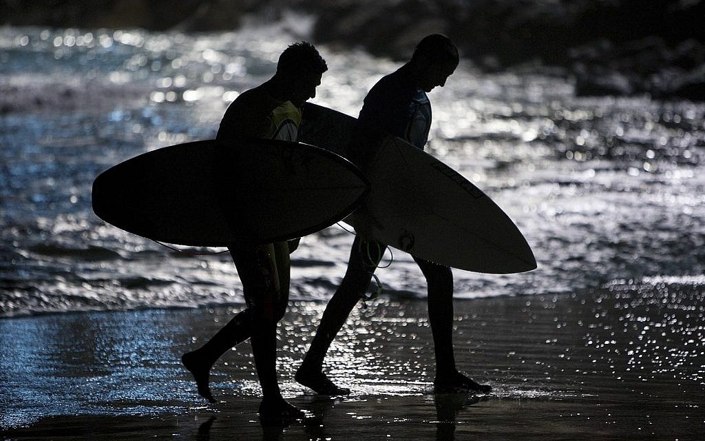 Israeli surfers walk out of the water after competing in a night surfing competition in the Mediterranean sea in Ashdod, southern Israel, Wednesday, Feb. 4, 2015 (AP Photo/Oded Balilty) Israeli surfers walk out of the water after competing in a night surfing competition in the Mediterranean sea in Ashdod, southern Israel, Wednesday, Feb. 4, 2015 (AP Photo/Oded Balilty)