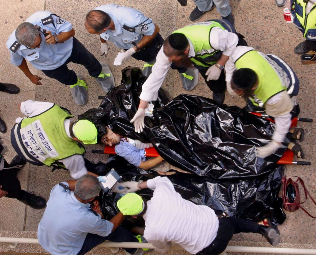 In this July 31, 2002 file photo. police and volunteers examine the body of one of the victims of an explosion at Hebrew University of Jerusalem. (photo credit: AP/John McConnico, File) In this July 31, 2002 file photo. police and volunteers examine the body of one of the victims of an explosion at Hebrew University of Jerusalem. (photo credit: AP/John McConnico, File)