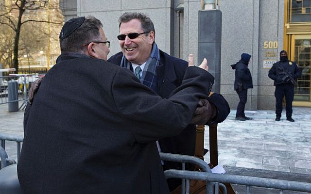 Attorney Kent Yalowitz, right, representing those affected by attacks in Israel in the early 2000s, hugs Mark Weiss of New York outside a federal courthouse in New York Monday, Feb. 23, 2015. The court found the Palestinian authorities liable in the attacks, with jurors awarding the victims $218.5 million in damages at a civil trial. (photo credit: AP Photo/Craig Ruttle)