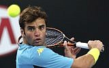 In this Friday, Jan. 23, 2015 file photo of Malek Jaziri of Tunisia, he plays a shot to Nick Kyrgios of Australia during their third round match at the Australian Open tennis championship in Melbourne, Australia. (AP Photo/Rob Griffith,File)