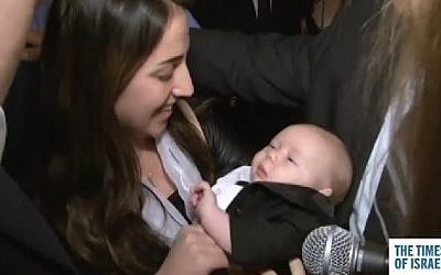 The wife of Zidan Saif, killed in the Har Nof terror attack in November 2014, meets Koby Zidan Chester at the TOI Gala on February 15, 2015, a two-month-old baby boy born to Alexander and Jennifer Chester from New York, who named their child after the fallen policeman. (Photo credit: Screenshot)