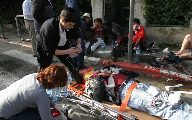 An injured man is evacuated from the scene of a terror attack in Jerusalem on the number 19 bus, on January 24, 2004 (photo credit: Flash90) An injured man is evacuated from the scene of a terror attack in Jerusalem on the number 19 bus, on January 24, 2004 (photo credit: Flash90)