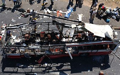 Police and paramedics inspect the scene after a suicide bomber blew himself up inside a rush-hour bus near the Jerusalem neighborhood of Gilo, June 18, 2002. At least 14 people were reported killed in the blast and around 40 injured. (photo credit: Flash90) 