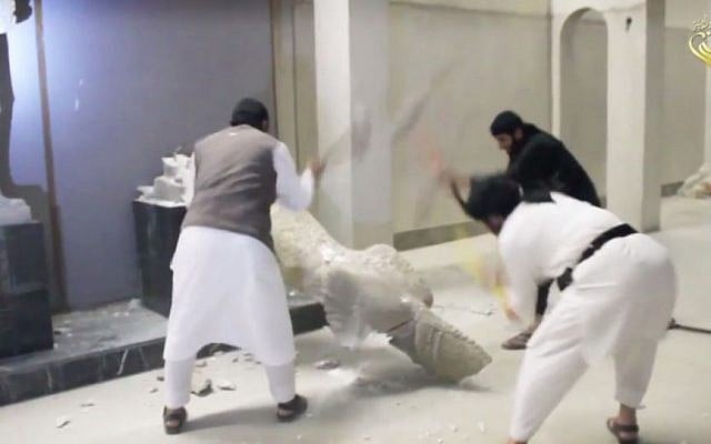 New IS video shows militants smashing ancient Iraq artifacts (photo credit: YouTube screen capture) New IS video shows militants smashing ancient Iraq artifacts (photo credit: YouTube screen capture)