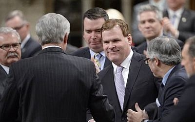 Canada's Foreign Minister John Baird is congratulated in the House of Commons in Ottawa on Tuesday, Feb. 3, 2015, after announcing his resignation from the Cabinet. (photo credit: AP Photo/The Canadian Press, Adrian Wyld)