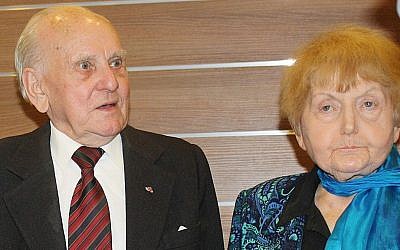 In this January 29, 2015 picture Jozef Paczynski, left, 95, a former Auschwitz prisoner who was the barber to camp commandant Rudolf Hoess, stands next to Eva Mozes Kor, 81, a Jewish survivor of experiments by the sadistic German doctor Josef Mengele, in Krakow, Poland. (photo credit: AP Photo/Alexandra Fletcher)