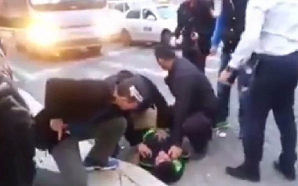 A Palestinian stabber is taken down by security guards in Jerusalem after attacking a 27-year-old Israeli man (photo credit: Screen capture)