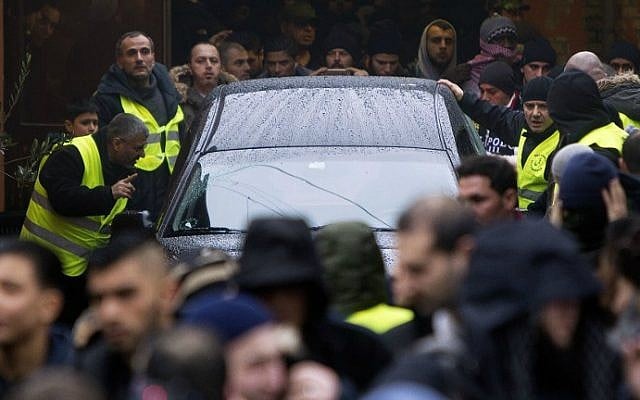 Mourners surround the hearse with late Omar Abdel Hamid El-Hussein leaving the Mosque on Dortheavej in Copenhagen driving to the Muslim cemetery in Broendby south of Copenhagen on February 20 2015. (photo credit: AFP/Scanpix Denmark/Nils Meilvang) Mourners surround the hearse with late Omar Abdel Hamid El-Hussein leaving the Mosque on Dortheavej in Copenhagen driving to the Muslim cemetery in Broendby south of Copenhagen on February 20 2015. (photo credit: AFP/Scanpix Denmark/Nils Meilvang)