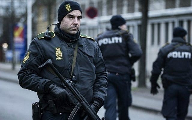 A police officer guards the street around the Noerrebro train station in Copenhagen on February 15, 2015 where a man has been shot in a police action following two fatal attacks in the Danish capital. (photo credit: AFP/Claus Bjorn Larsen)