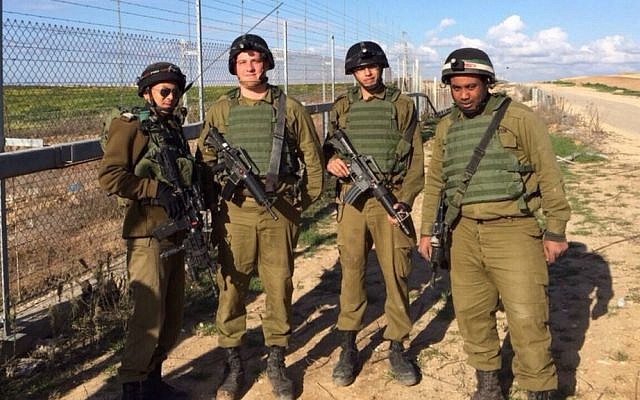Deputy unit commander, Sgt. First Class Reuven Tautang, left, and three Kometz soldiers along the fence (photo credit: IDF Spokesperson's Unit)
