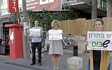 Shabus organizers stand outside Jerusalem's Lev Smadar Theater, a secular Jerusalemite hangout on Saturdays, holding signs that read, 'There is a solution, Shabus' (photo credit: Courtesy Shabus)