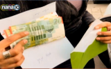 Lucky shoppers received hundreds of shekels from an anonymous millionaire in Kfar Saba on Feb. 25, 2015. (Screen capture)