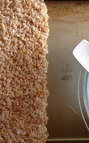 Spread the Rice Krispie mixture into a big block before cutting into triangles (Rebecca Pliner/JTA) Spread the Rice Krispie mixture into a big block before cutting into triangles (Rebecca Pliner/JTA)