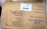 An envelope containing exams, on top of which were written orders not to write BS"D on the classroom board. (photo credit: Facebook screen capture)