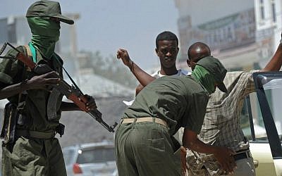 Somalia federal government soldiers conduct a random check of public transport vehicles during a patrol on the streets of Mogadishu on February 18, 2015, as part of an operation against al-Shabab insurgents (photo credit: AFP/Mohamed Abdiwahab)