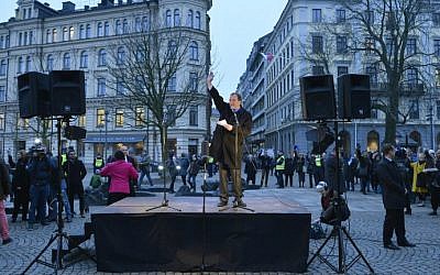 Swedish Prime Minister Stefan Loefven delivers a speechas people gather to form a 'ring of peace' around the big synagogue at Raoul Wallenbergs place in central Stockholm, on February 27, 2015. (photo credit: AFP/TT News Agency/ Henrik Montgomery)