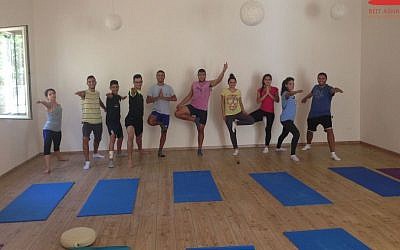 At Beit Ashams, yoga practitioners in warrior and tree poses. (photo credit: Courtesy of Beit Ashams/shams.ps/JTA) 