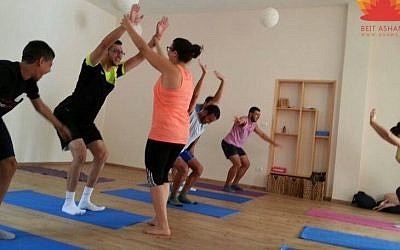 Yoga practitioners at Beit Ashams in Beit Jala practicing the chair pose. (photo credit: JTA/Courtesy of Beit Ashams/shams.ps)