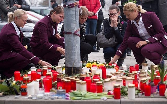 Employees of German airline Germanwings mourn after a minute of silence for the victims of the Germanwings plane crash in front of the company's headquarters in Cologne, western Germany, on March 25, 2015. (photo credit: AFP PHOTO / DPA / MARIUS)
