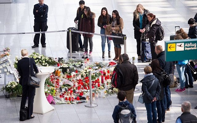 People pay their respects at a memorial with messages, candles and flowers for the victims of the Germanwings plane crash in the French Alps can be seen at the airport in Duesseldorf on March 28, 2015. (photo credit: AFP/DPA/MARIUS BECKER) People pay their respects at a memorial with messages, candles and flowers for the victims of the Germanwings plane crash in the French Alps can be seen at the airport in Duesseldorf on March 28, 2015. (photo credit: AFP/DPA/MARIUS BECKER)