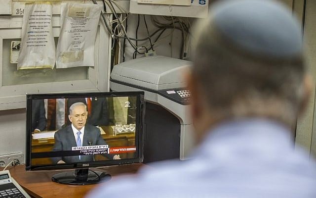 An Israeli man watches a television broadcast of Prime Minister Benjamin Netanyahu addressing the US Congress at the US Capitol in Washington, at a Likud party headquarters in the coastal city of Netanya, on March 3, 2015. (photo credit: AFP PHOTO / JACK GUEZ) An Israeli man watches a television broadcast of Prime Minister Benjamin Netanyahu addressing the US Congress at the US Capitol in Washington, at a Likud party headquarters in the coastal city of Netanya, on March 3, 2015. (photo credit: AFP PHOTO / JACK GUEZ)