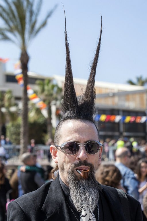 A dressed up Israeli takes part in a parade during the festivities of the Jewish Purim festival on March 5, 2015 in the central Israeli city of Netanya. (photo credit: AFP PHOTO / JACK GUEZ) A dressed up Israeli takes part in a parade during the festivities of the Jewish Purim festival on March 5, 2015 in the central Israeli city of Netanya. (photo credit: AFP PHOTO / JACK GUEZ)