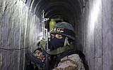Palestinian terrorists from the Islamic Jihad's armed wing, the Al-Quds Brigades, squat in a tunnel, used for ferrying rockets and mortars back and forth in preparation for the next conflict with Israel, as they take part in military training in the south of the Gaza Strip, on March 3, 2015. (AFP/Mahmud Hams)