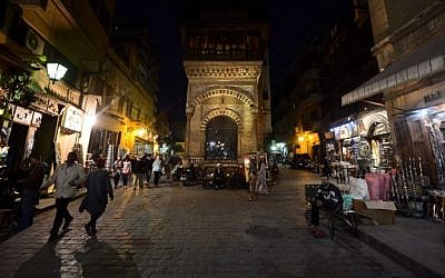 People walk past shops in the Khan el-Khalili district of Cairo, Egypt, March 7, 2015. (photo credit: AFP/Mohamed el-Shahed)