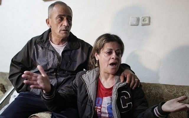 The parents of Arab-Israeli Muhammad Musallam react at the family's home in the Beit Hanina neighborhood of East Jerusalem on March 10, 2015, after the Islamic State (IS) released a video purportedly showing a young boy executing their son. (photo credit: AFP / AHMAD GHARABLI) The parents of Arab-Israeli Muhammad Musallam react at the family's home in the Beit Hanina neighborhood of East Jerusalem on March 10, 2015, after the Islamic State (IS) released a video purportedly showing a young boy executing their son. (photo credit: AFP / AHMAD GHARABLI)