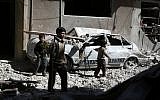 Syrian children walk through the debris in the rebel-held area of Douma, east of the capital Damascus, following reported air strikes by regime forces on March 13, 2015. (photo credit: AFP/ABD DOUMANY)