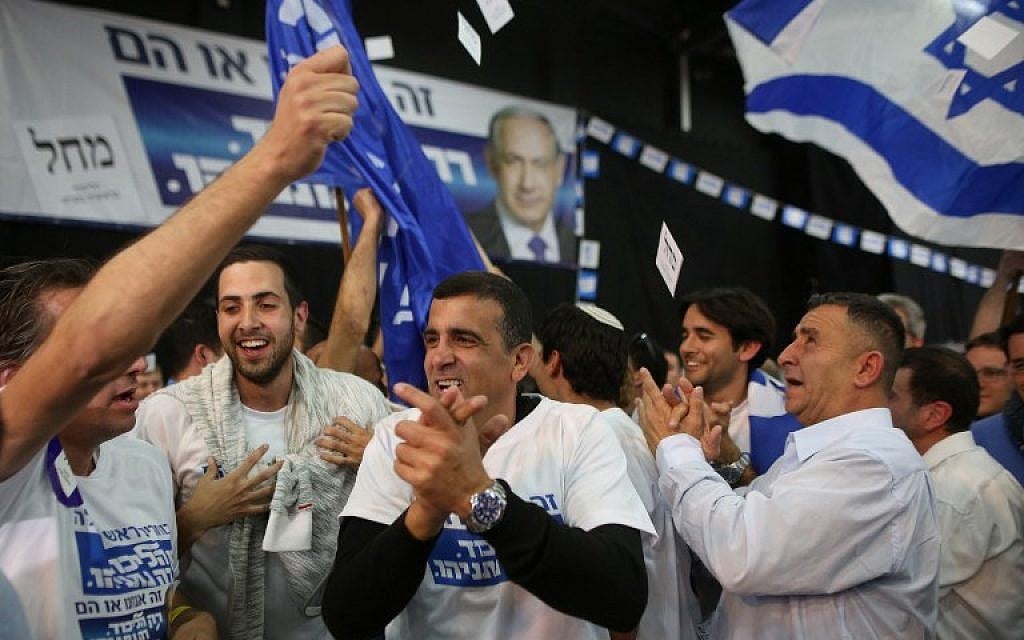 Likud party supporters react to exit polls while they wait at the party's headquarters in Tel Aviv for the announcement of the official results of the Knesset elections on March 17, 2015. (AFP/Menahem Kahana)