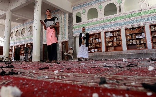 Yemeni armed men inspect the damage following a bomb explosion at the Badr mosque in southern Sanaa on March 20, 2015. (Photo credit: AFP/ MOHAMMED HUWAIS) Yemeni armed men inspect the damage following a bomb explosion at the Badr mosque in southern Sanaa on March 20, 2015. (Photo credit: AFP/ MOHAMMED HUWAIS)