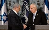 Prime Minister Benjamin Netanyahu (L) shakes hands with Israeli President Reuven Rivlin as he is formally given the task to form the next government, at the president's residence in Jerusalem on March 25, 2015. (photo credit: AFP PHOTO / MENAHEM KAHANA)